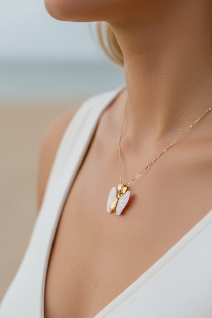 Pink iridescent gold shell butterfly angel wing necklace on a woman's neck