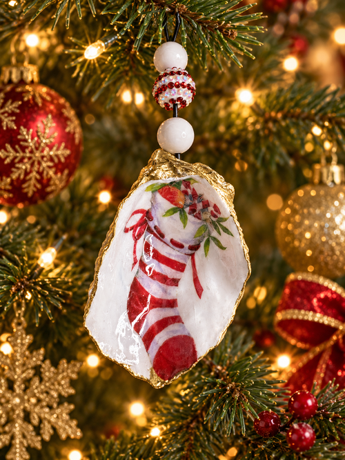 Beaded candy cane stocking shell ornament hanging on a decorated Christmas tree